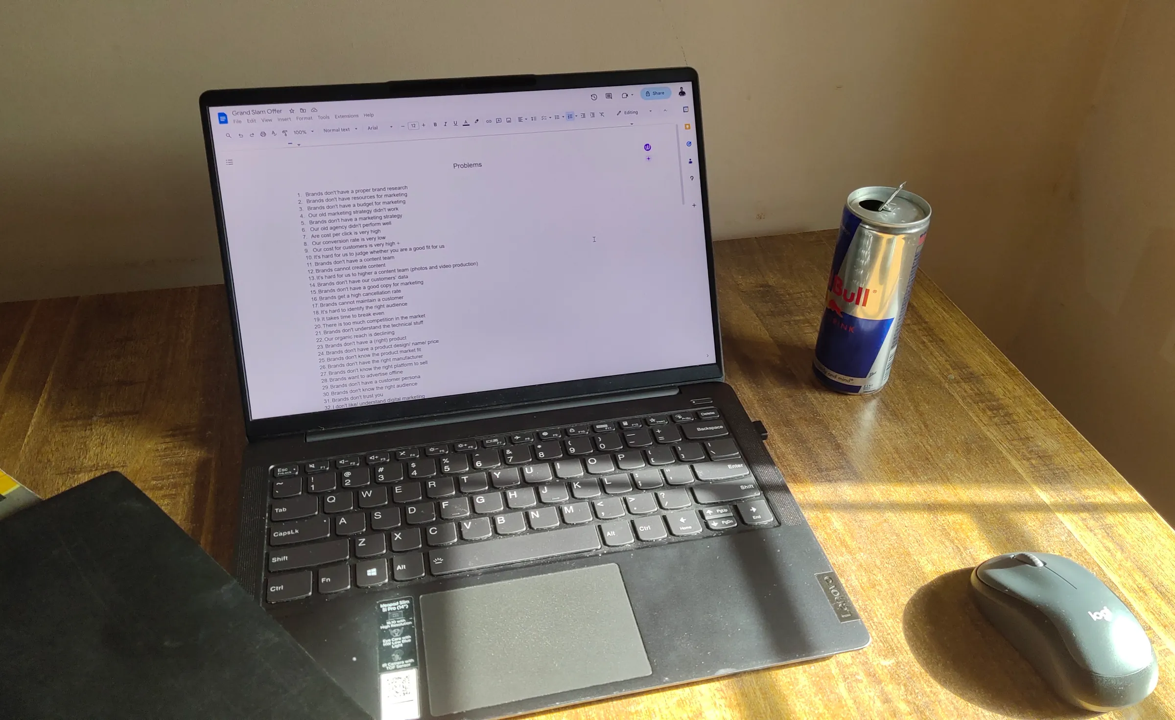 The desk where Donemint started: a laptop open on a to-do list, a mouse and an energy drink in the afternoon sun